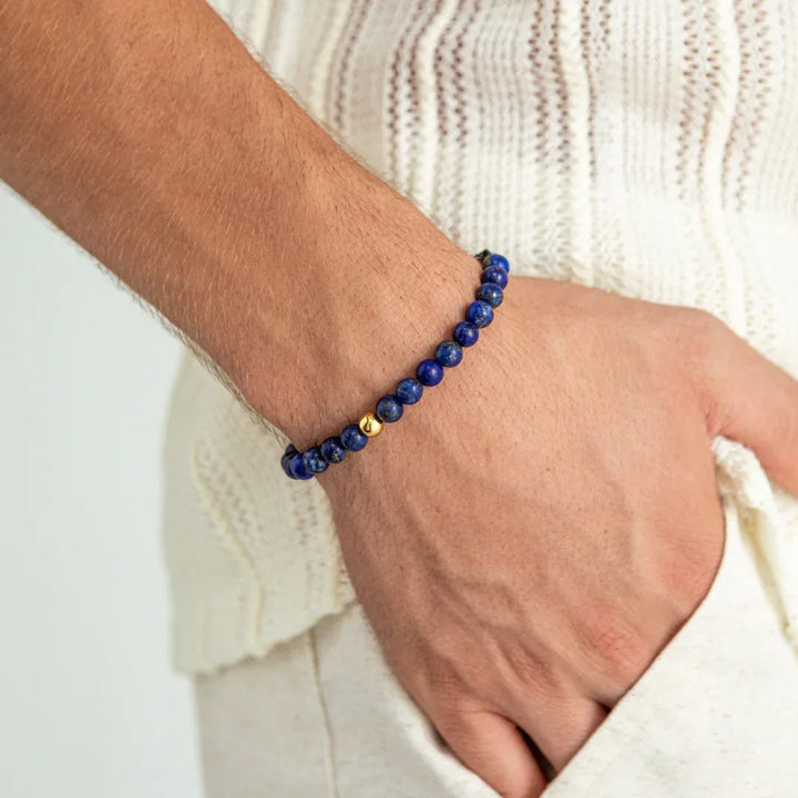 Alexander Lynggaard Bracelet Lapis Braided 6mm is worn on the wrist, blue stone beads with gold detail. Model B00152-2