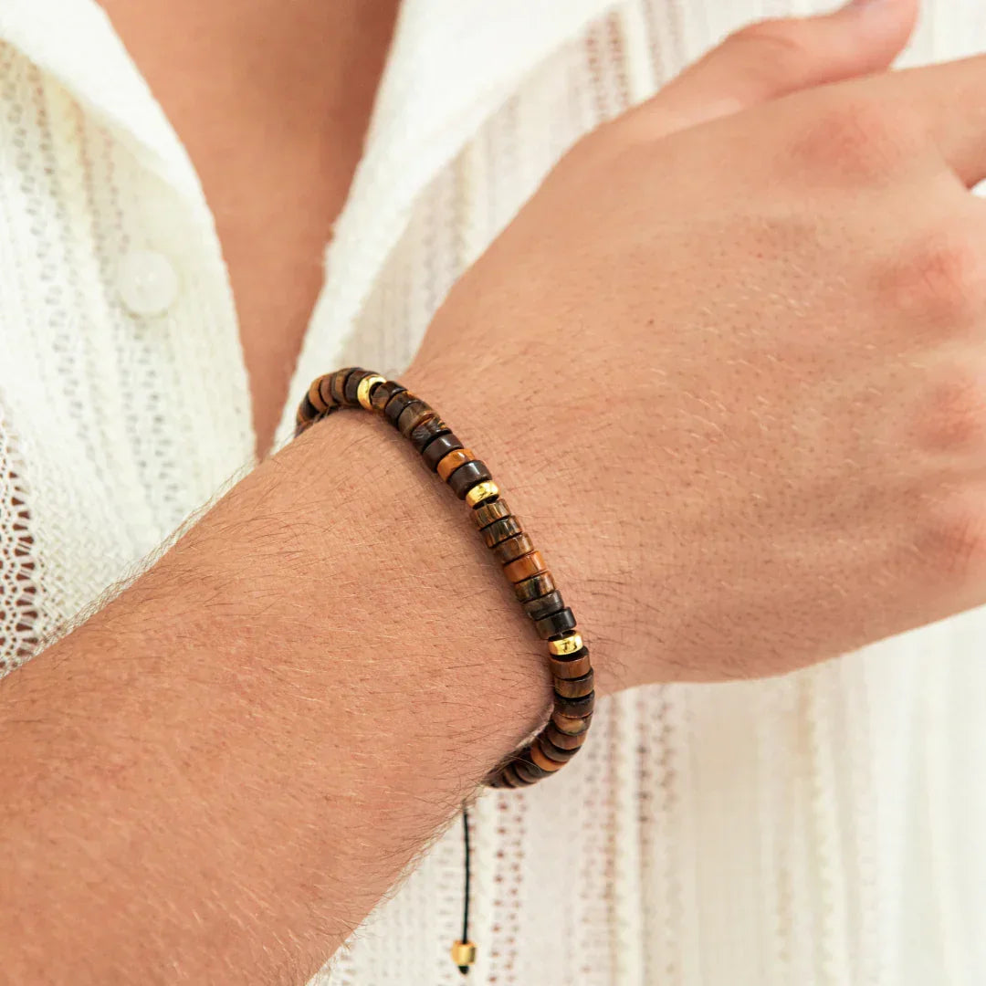 Alexander Lynggaard Bracelet Tiger Eye Heishi Braided 6mm shown on hand, brown and gold details. Model B00202-1