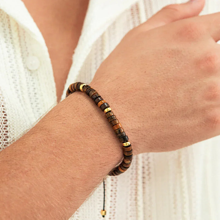 Alexander Lynggaard Bracelet Tiger Eye Heishi Braided 6mm shown on hand, brown and gold details. Model B00202-1