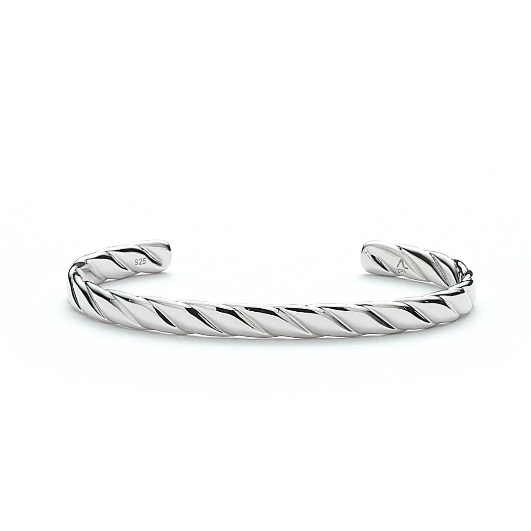 Alexander Lynggaard Hope Bangle in silver with a twisted, shiny surface in a bright study. Model H20073-001-1