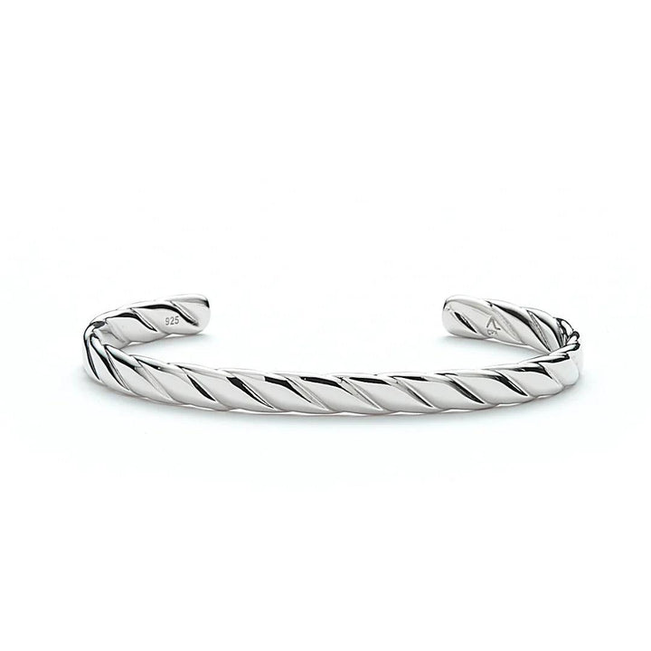 Alexander Lynggaard Hope Bangle in silver with a twisted, shiny surface in a bright study. Model H20073-001-1
