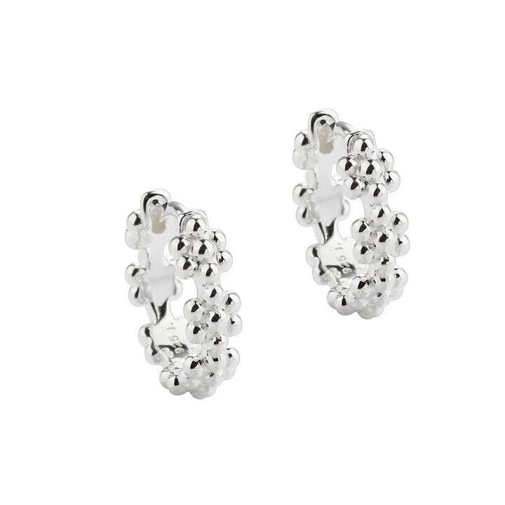 Aqua Dulce Lots of Flowers Hoop Silver 13mm 5705–1 shows a pair of silver hoops with floral details. Model 5705–1.