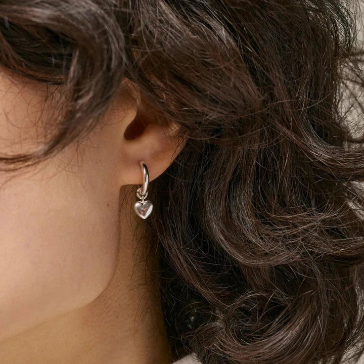 Enamel Amore Solv Hoops shown on ear, silver heart pendant earring. Model e376s-e376s-2.