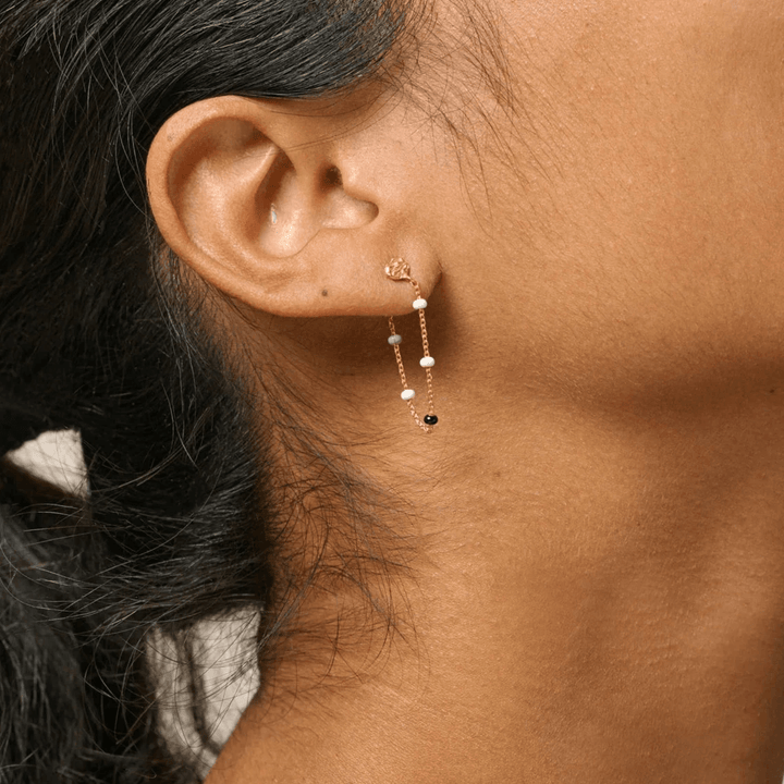 Enamel Lola Salt n Pepper Earrings show on ear, gold earring with fine chains and pearls, Model e140gm-salt pepper