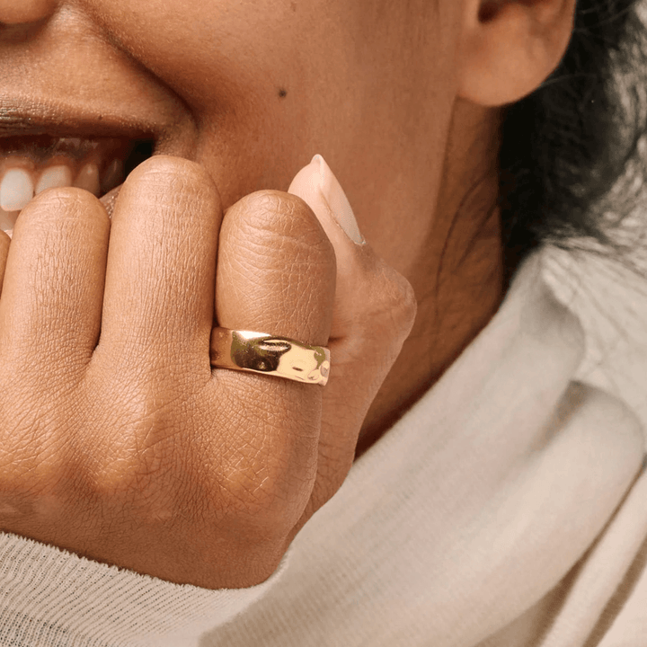 enamel sandra gold plated ring appears on a woman's hand, wide shiny gold colored surface, Model R91G-R91G-001-2