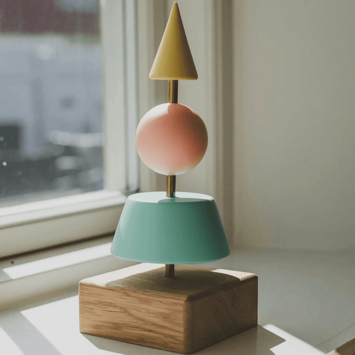Fablewood Christmas tree Helga-1213 with geometric tree shapes in yellow, green and pink shades on an oak base. Model 1213-1