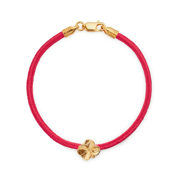 Flora Danica Firklover Silk Bracelet Coral Red shown here with red silk cord and gilded clover detail. Model 907-flc-silk-red-g-001-1.