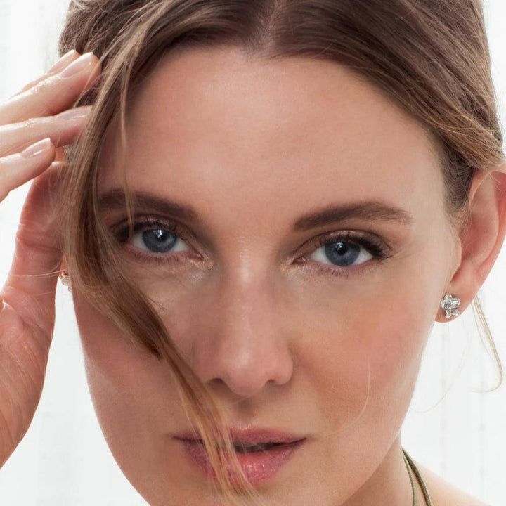 Flora Danica Medium Forget-me-not earrings in silver shown on model, elegant detail, Model 907-FMN-STPC-MEDIUM-S.