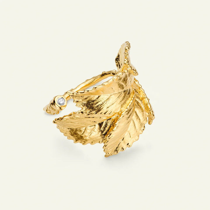 Flora Danica Rose Petal Statement Ring with Diamond shows a gold-plated, leaf-shaped ring with a single diamond. Model stri-g-001-2.