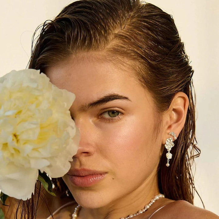 Hultquist Copenhagen Lainey Grande silver earrings, worn by model with wet hair and flower. Model S08609S-2