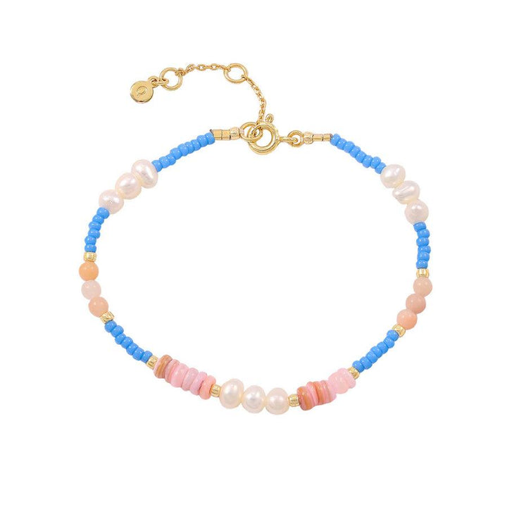 Hultquist Gabbie bracelet with blue pearls, pink details and adjustable gold-colored clasp. Model S08527G-1.