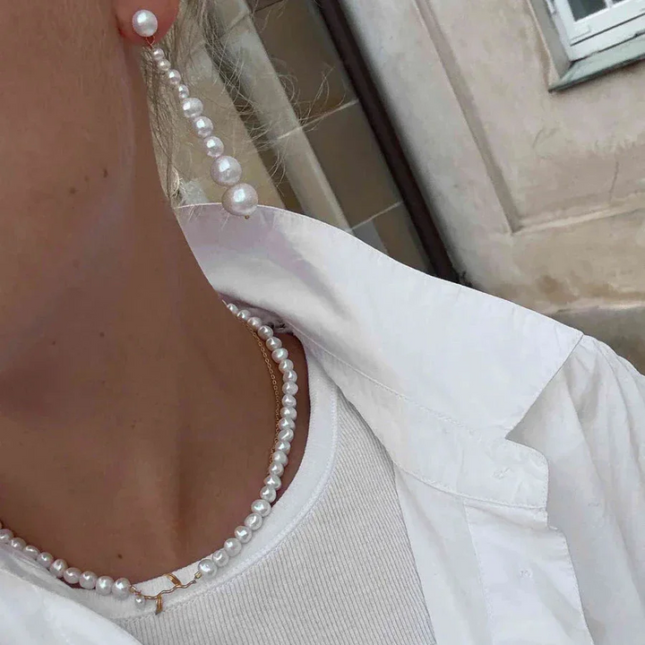 Hultquist Marigold Pearl necklace seen on neck, classic string of pearls in white. Model S08660G-2.