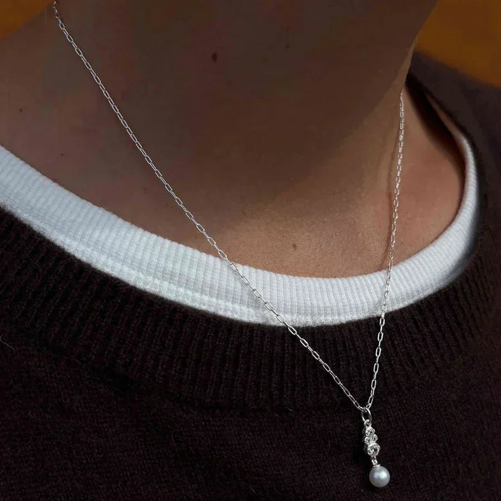 Hultquist Scarlet necklace 925 sterling silver shown on model, single chain with pearl pendant. Model S08631S-2