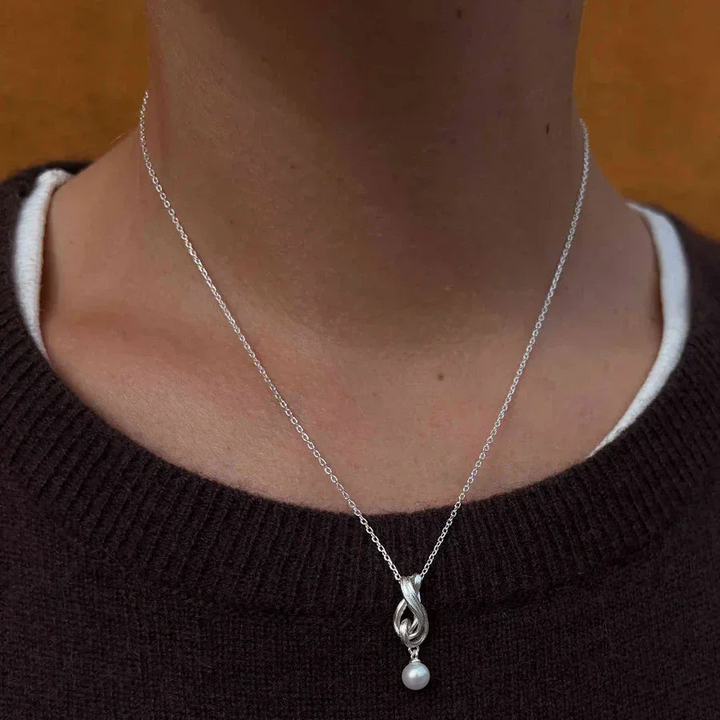 Hultquist Tiril necklace 925 sterling silver with twisted pendant and pearl on model. Model S08646S-2