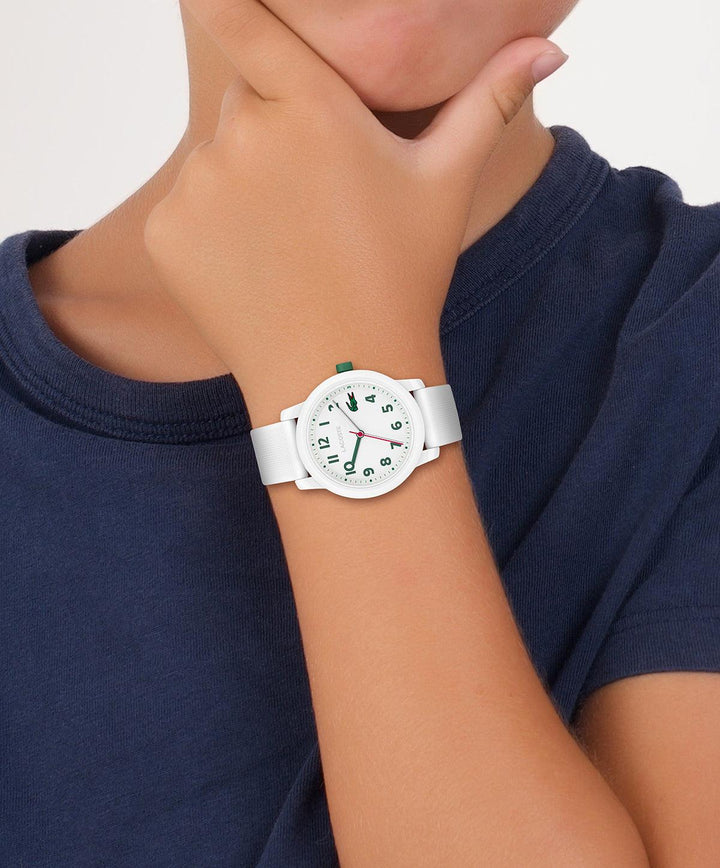 Lacoste Junior WATCH 12.12 white watch on a child's wrist, simple style with white strap. Model 203003-2