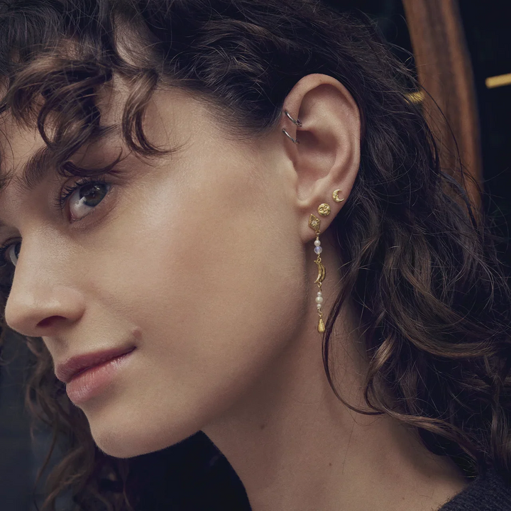 moonstone emma gold-plated ear studs appear on the ear, elegant in gold with pearl detailing. Model 10045a