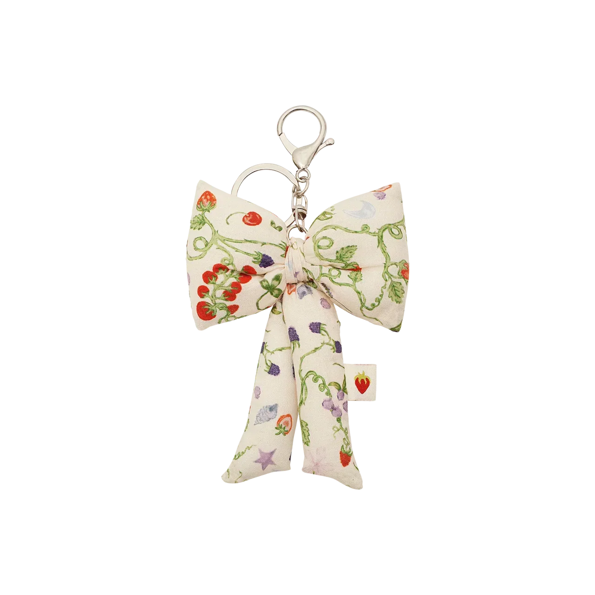 The Maanesten Fabric Bow Key Ring Garden Magic Ivory features a large floral print fabric bow and silver colored key hook. Model 4111