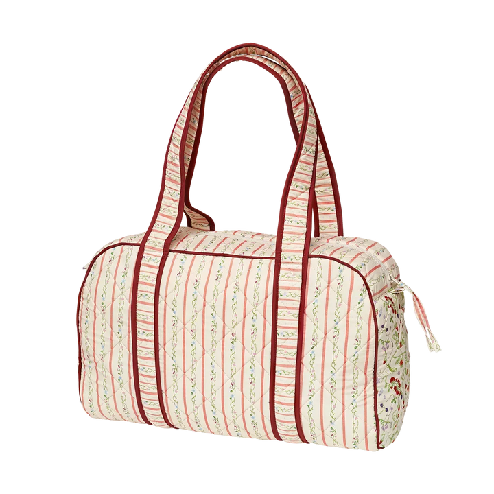 Maanesten Suvi Quilted Bag Summer Stripes Peach viewed from the side with light stripes and quilted fabric. Model 4115.