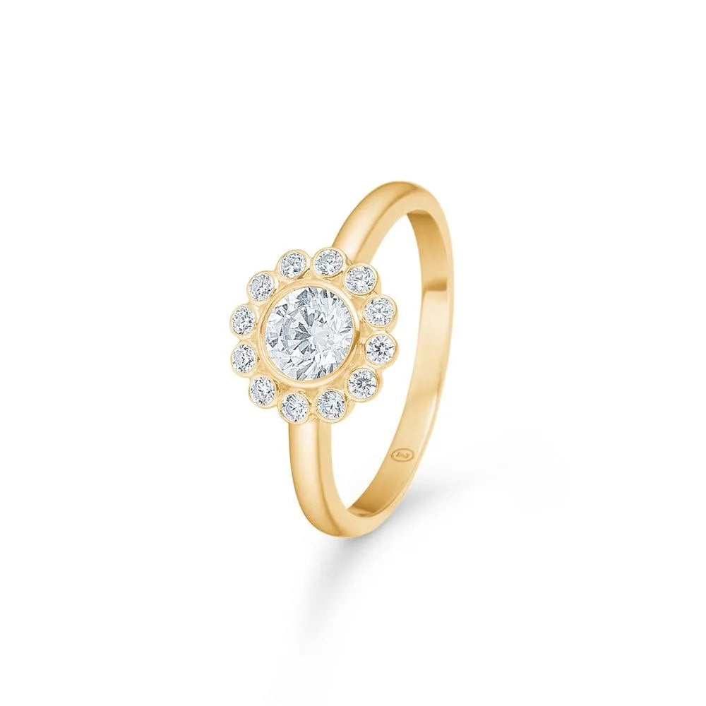 Mads Z 8kt Carmen Ring Zirkonia shows gold ring with round zirconia center and border of small stones. Model 3347045-001.