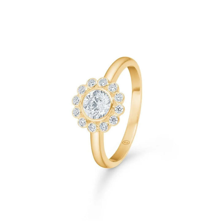 Mads Z 8kt Carmen Ring Zirkonia shows gold ring with round zirconia center and border of small stones. Model 3347045-001.
