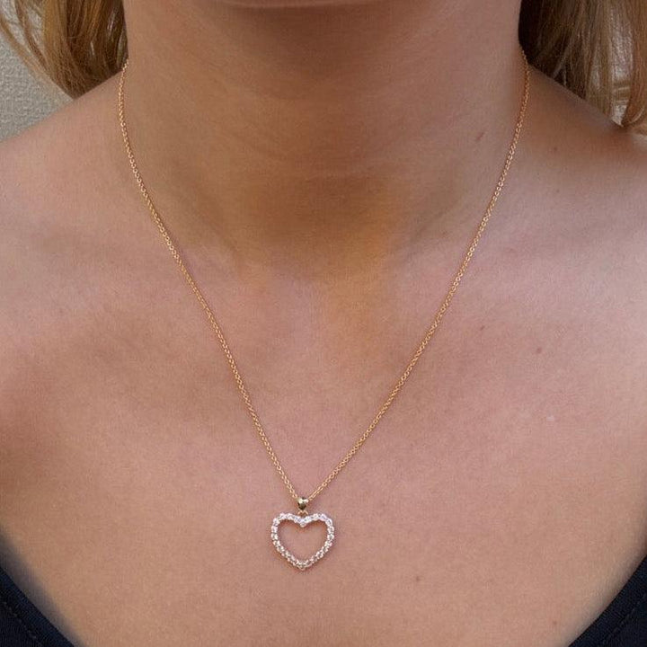 Mads Z 8kt Rhianna pendant heart motif worn around the neck, visible in gold with clear stones. Model 3337076-2