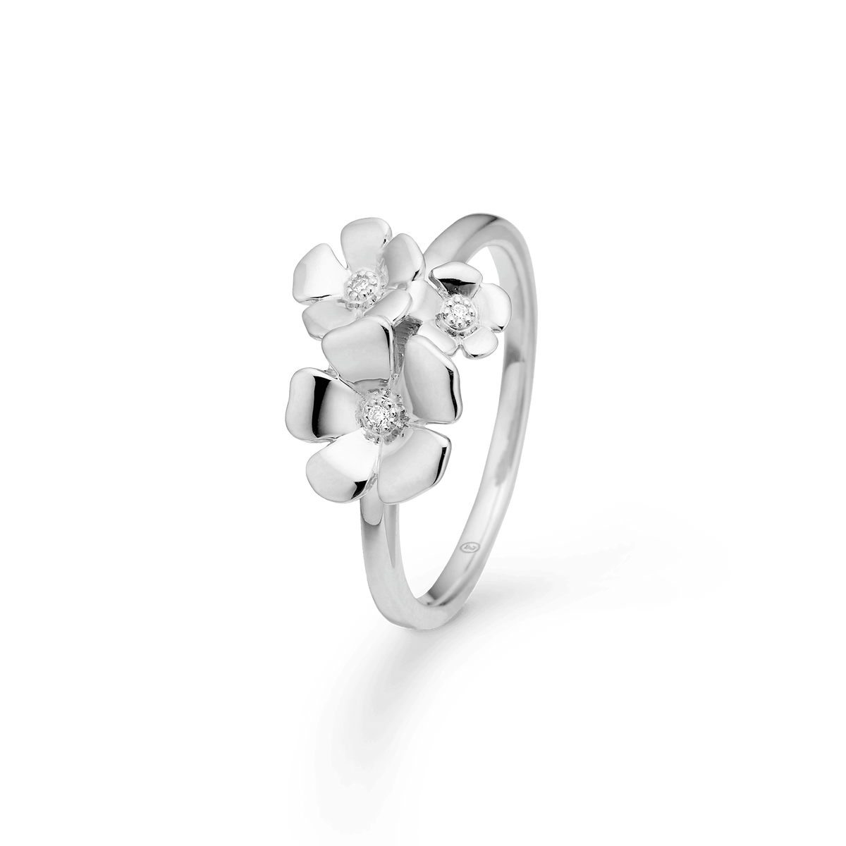 Mads Z Fleur Silver Ring with White Topaz shows an elegant silver ring with three flowers and clear stones. Model 2146108-001