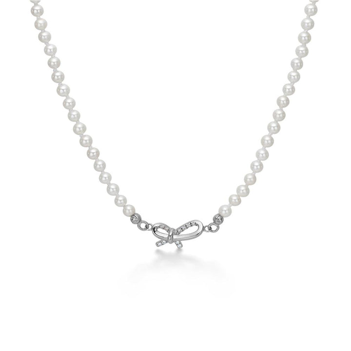 Mads Z Miss Butterfly silver pearl necklace with bow pendant, white pearls and clear bow design. Model 2123030