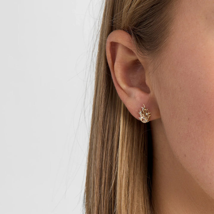 Mads Z Reef earrings in 8kt gold with zirconia appear worn on the ear, elegant and shiny. Model 3317024-2