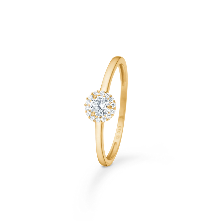 Mads Z Vega 8kt gold ring w/zirconia shown with round clear stone surrounded by small stones, Model 3347060-001.