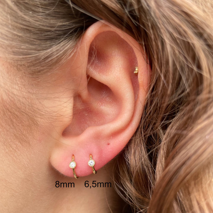 Maria Tash 8mm Scalloped Diamond Hoop Clicker is shown in ear, gold-tone and with diamond detail. Model xrscd-yg-d8-2.