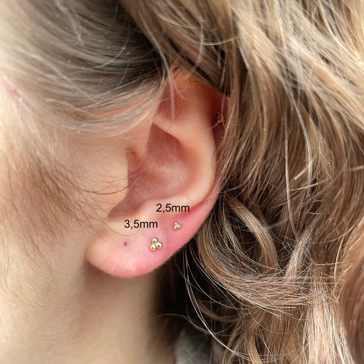 Maria Tash Large Three Ball Trinity Threaded Stud in gold worn in ear, minimalist style. Model 35mm-x3btrl-001.