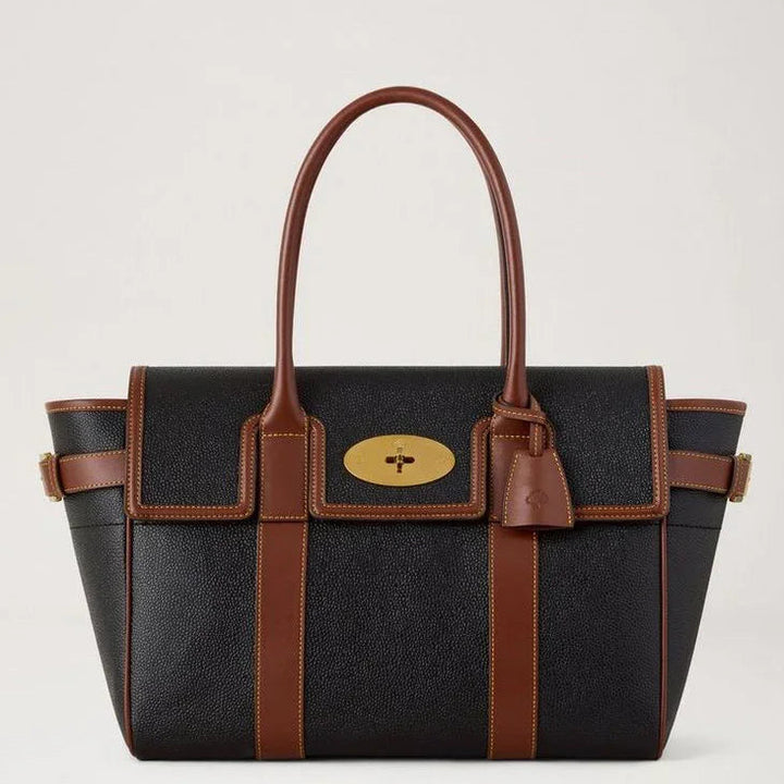 Mulberry Bayswater Black and Cognac Bio-based Scotchgrain shows a spacious black bag with brown details. Model HH0014127A340
