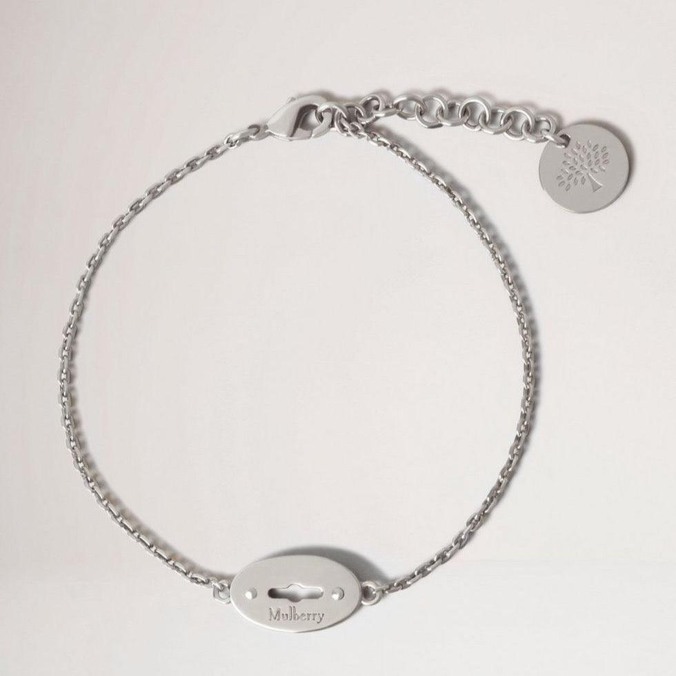 Mulberry Bayswater Bracelet Sterling Silver shows an elegant, silver colored bracelet with logo pendant. Model qb2397000d130-001-1