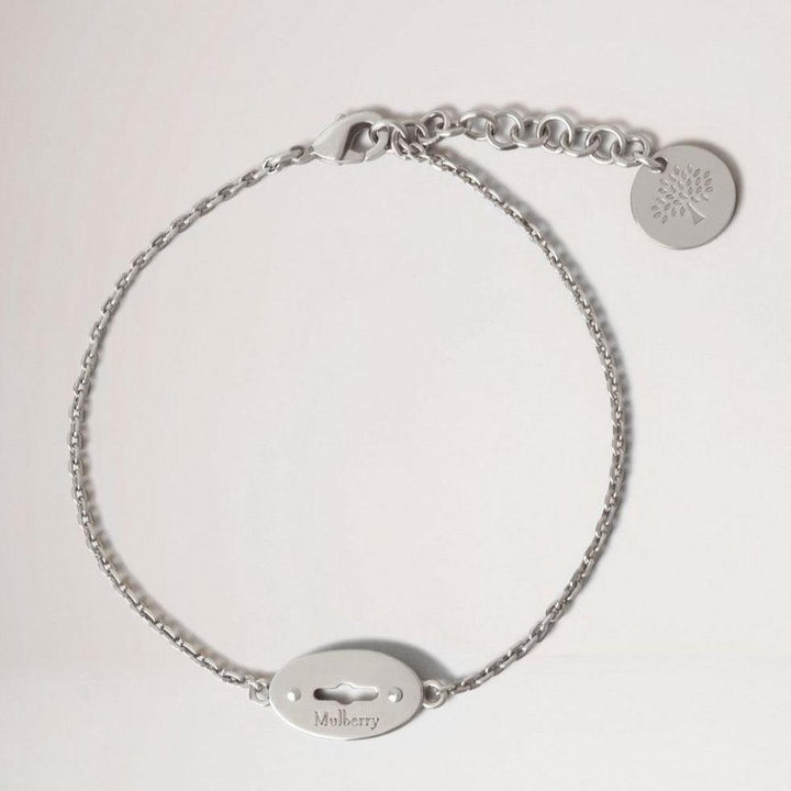 Mulberry Bayswater Bracelet Sterling Silver shows an elegant, silver colored bracelet with logo pendant. Model qb2397000d130-001-1