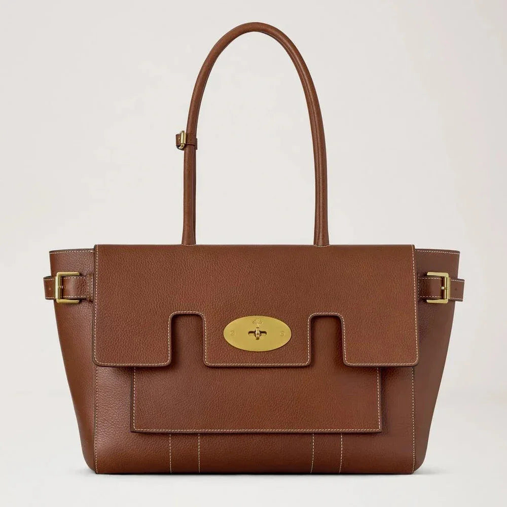 Mulberry Buckle Bayswater Oak NVT shows a large brown leather bag with golden buckles and bright stitching. Model HH9964730G110