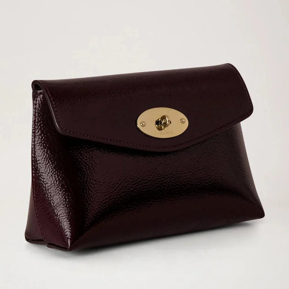 Mulberry Darley Cosmetic Pouch Deep Aubergine Patent features a glossy dark purple cosmetic pouch with golden buckle. Model rl8932737v697.