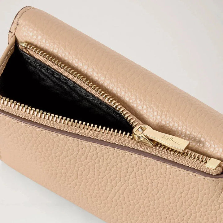 Mulberry Darley Folded Multicard Wallet Crumpet shows closeup of beige leather wallet with gold zipper and black lining. Model RL6665205W577.
