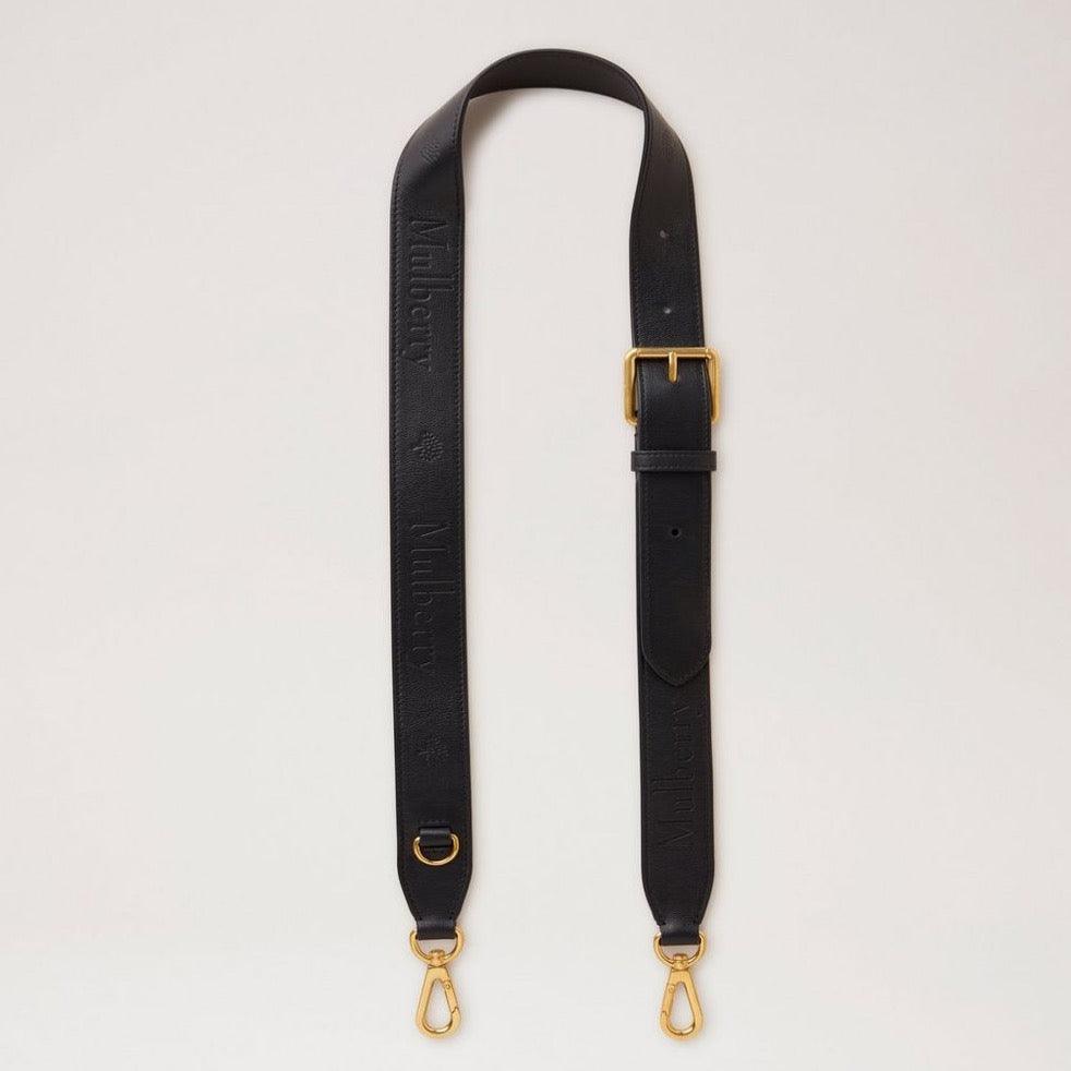 Mulberry debossed logo leather strap in black leather with adjustable buckle and golden metal parts. Model RX0284587A100.
