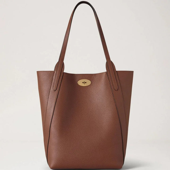 Mulberry North South Bayswater Heavy Grain Bright Oak showcases a roomy brown leather bag with two handles and gold detailing. Model hh9104736g222.