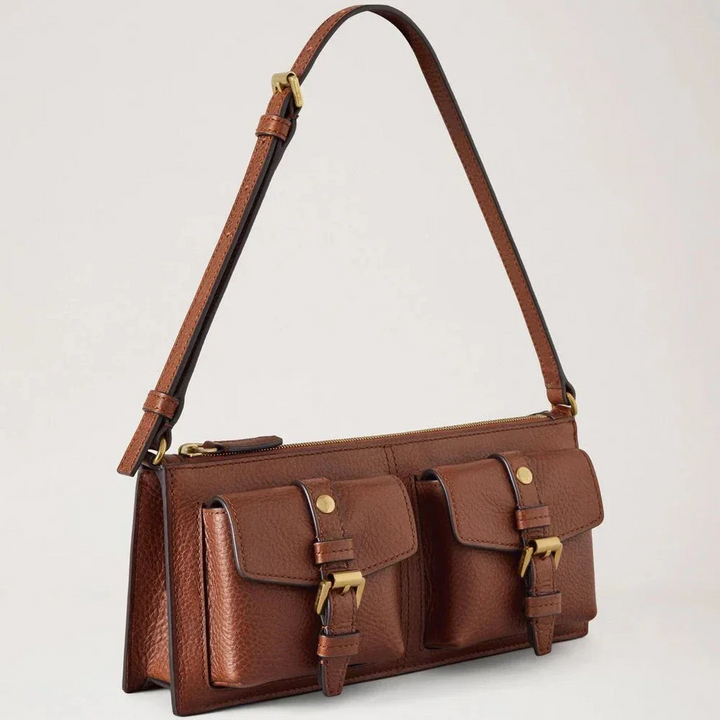 Mulberry Roxanne Mini Shoulder Bag shows a compact shoulder bag in brown leather with two front pockets and golden buckles. Model RL8902730G110