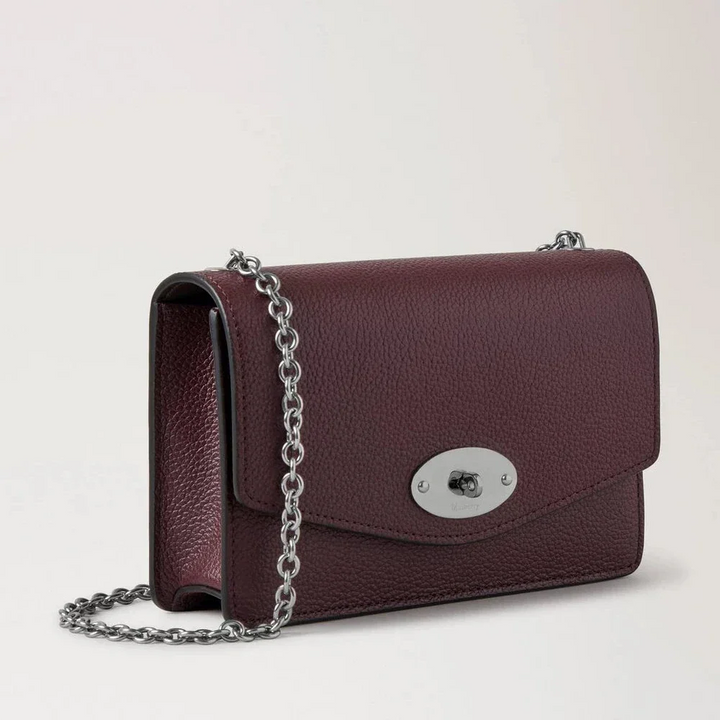 Mulberry Small Darley Small Classic Grain Black Cherry shows a small shoulder bag in dark red leather with silver chain strap and clasp. Model RL7791/205K560