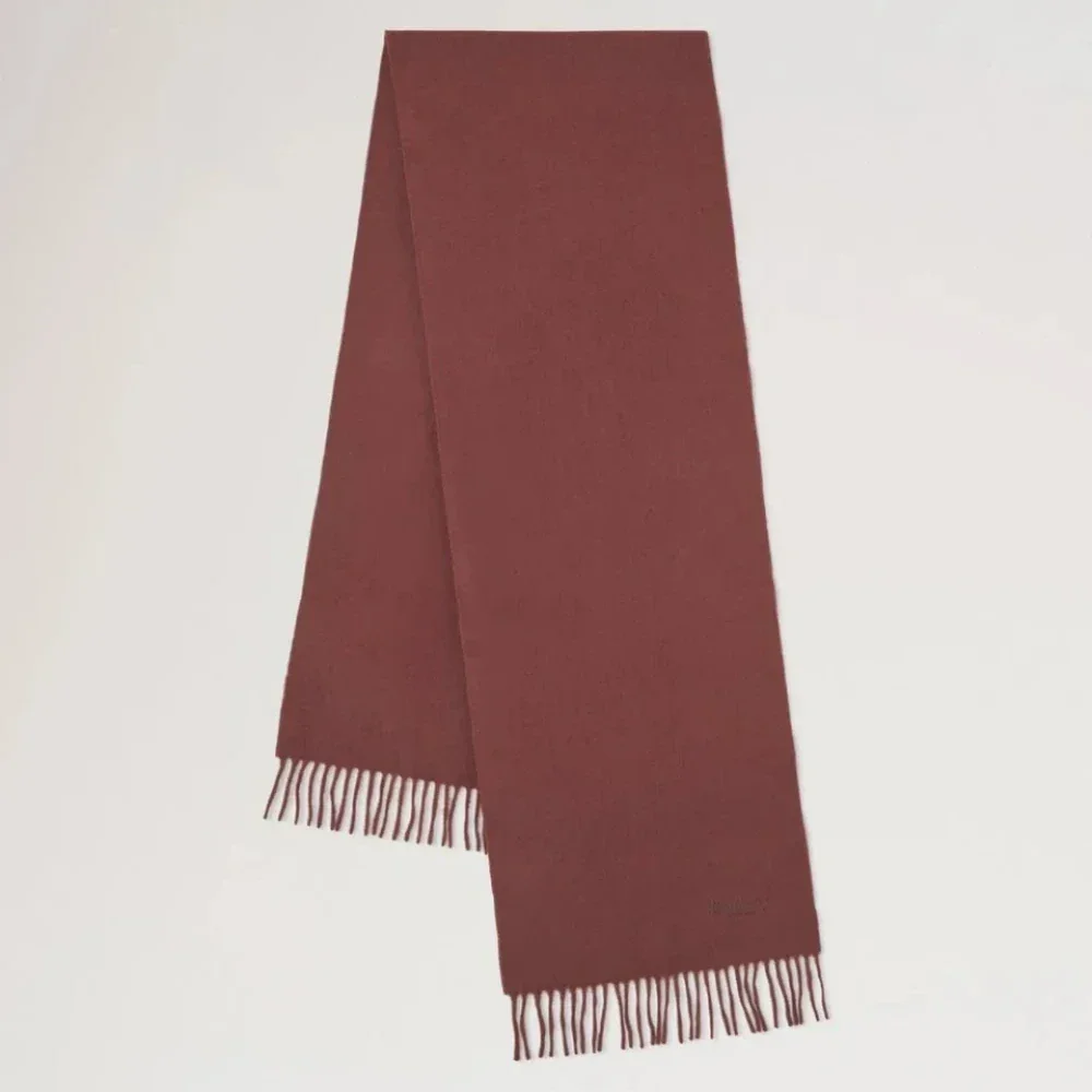 Mulberry Small Solid Merino Wool Scarf shows a solid brown wool scarf with fringes. Model VS4318946G222