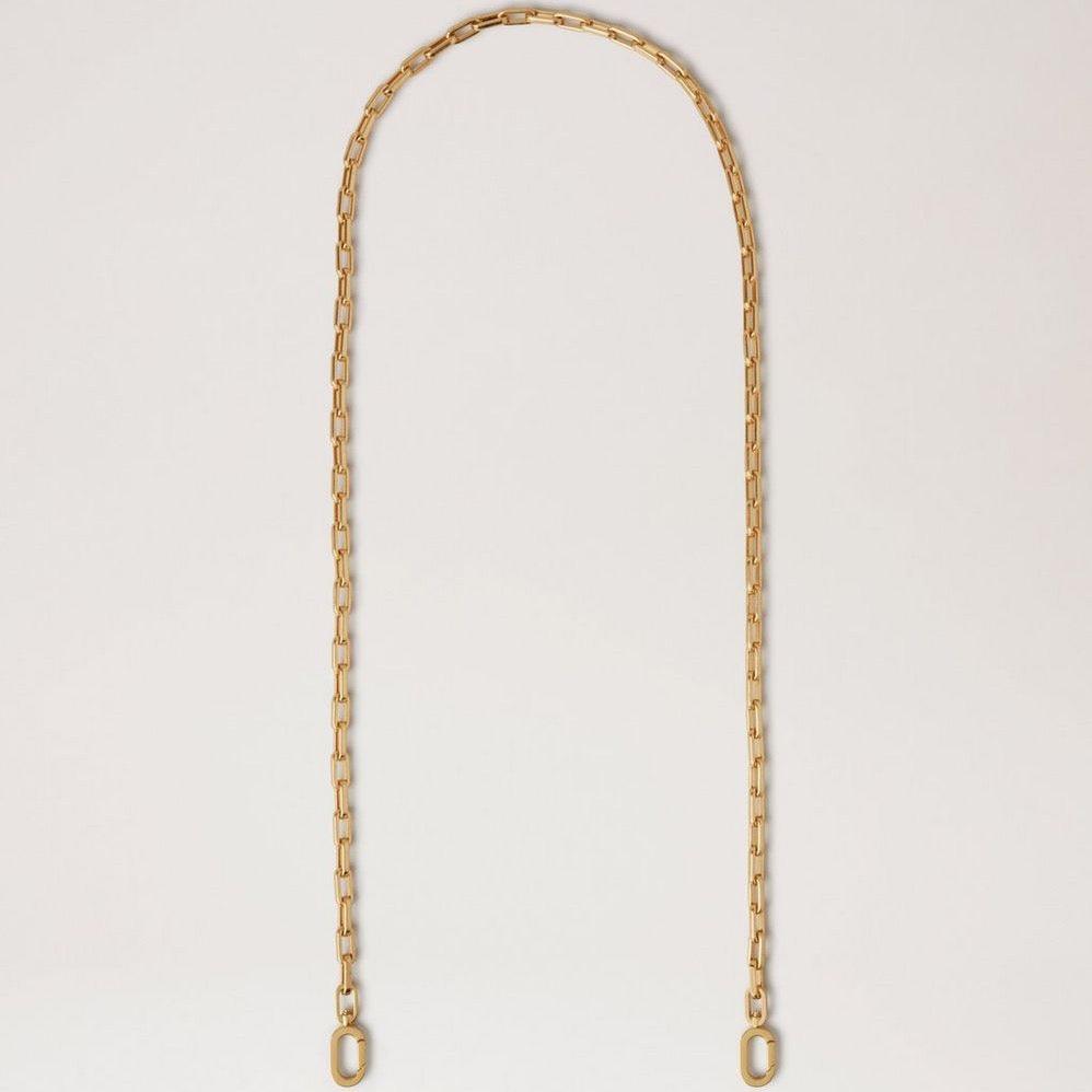 Mulberry Softie Chain Crossbody Strap in shiny brass colored metal, elegant chain against light background. Model RX0289000N188