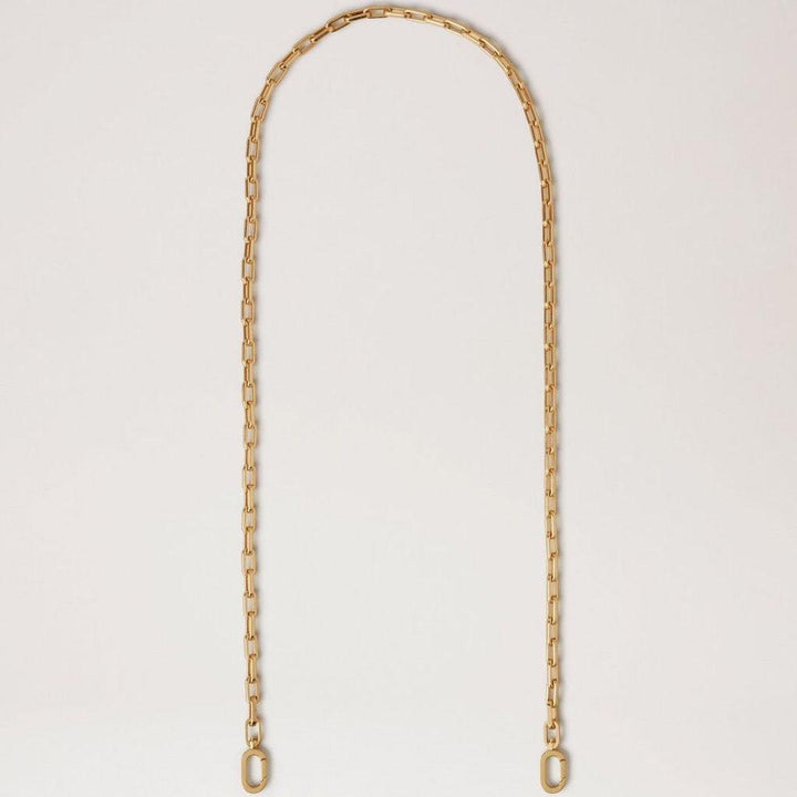 Mulberry Softie Chain Crossbody Strap in shiny brass colored metal, elegant chain against light background. Model RX0289000N188