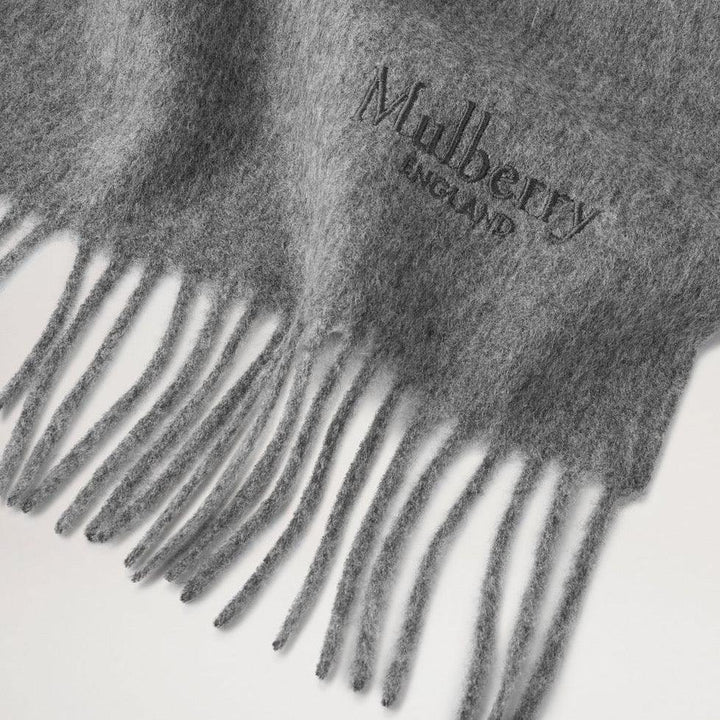 Mulberry Solid Merino Wool Scarf Gray Melange shows close-up of soft gray wool and fringe. Model VS4240947C601