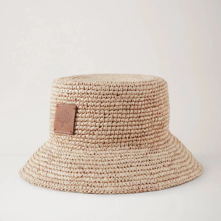 Mulberry Summer Raffia Bucket Hat shows a bright braided raffia summer hat with leather patch. Model VH4097807H120.