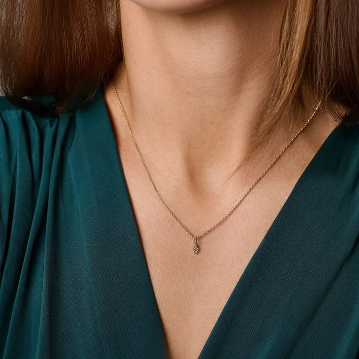 Nuran Athene 14kt Pendant 0.04ct W/SI shown close to a woman's neck, elegant in gold with diamond. Model v2560-004rg-2