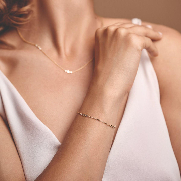 Nuran Champagne bracelet with diamonds worn on wrist in pink top, Model b3090ch-021rg