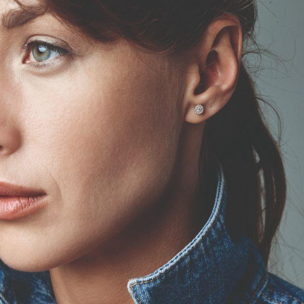 Nuran Cordelia Diamond stud earrings in 14kt gold seen on woman, round model with discreet sparkle, Model o2136-022rg-2.