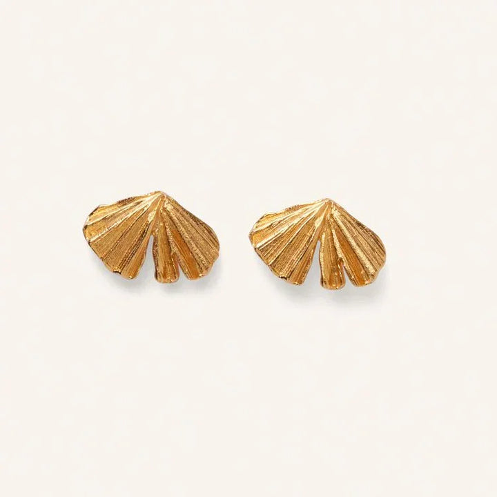 Pernille Corydon Autumn Leaf earrings in gold-plated, leaf-shaped detail on a light background. Model E-496-GP
